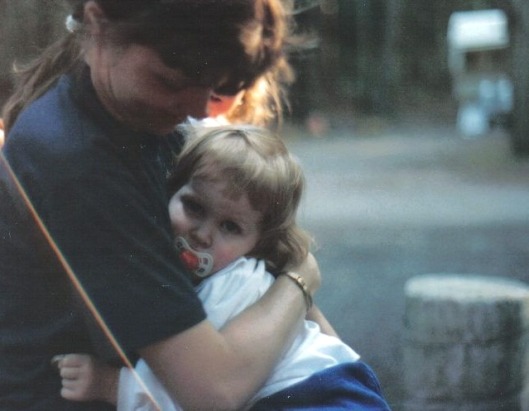 Mom comforting a two year old me after a taking a tumble.